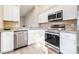 Modern kitchen with stainless steel appliances and granite countertops at 354 Ixora Dr, Palm Harbor, FL 34684