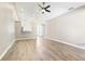 Spacious living room featuring light walls, wood-look floors, and a ceiling fan at 354 Ixora Dr, Palm Harbor, FL 34684