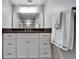 Modern bathroom featuring white vanity with granite countertop and decorative hand towels at 360 N Bayshore Blvd # 207, Clearwater, FL 33759