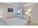 Light-filled bedroom with white furniture, ceiling fan, carpet, and a view into the living area at 360 N Bayshore Blvd # 207, Clearwater, FL 33759