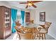 Cozy dining area with a glass-top table, four wicker chairs, and bright blue curtains at 360 N Bayshore Blvd # 207, Clearwater, FL 33759