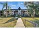 Charming condo building showcasing Tudor style architecture with black and white detailing and lush landscaping at 360 N Bayshore Blvd # 207, Clearwater, FL 33759