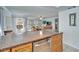 Kitchen counter extending into the living room, with stainless steel dishwasher and wooden cabinetry at 360 N Bayshore Blvd # 207, Clearwater, FL 33759