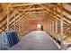 Unfinished attic space with high ceilings and plywood flooring at 3717 Quail Nesting Pl, Plant City, FL 33565