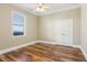 Charming bedroom with hardwood floors and a large window at 3717 Quail Nesting Pl, Plant City, FL 33565