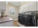 Laundry room with modern washer and dryer, and built in cabinets at 3717 Quail Nesting Pl, Plant City, FL 33565