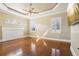 Hardwood floor living room with fireplace and large windows at 3717 Quail Nesting Pl, Plant City, FL 33565