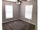 Bright bedroom with two windows, carpet, and ceiling fan at 3863 Island Way, St Petersburg, FL 33705