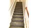 Carpeted staircase with wooden railing at 3863 Island Way, St Petersburg, FL 33705