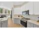 Modern kitchen with gray and white cabinets and quartz countertops at 4325 Swift Cir, Valrico, FL 33596