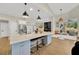 Open kitchen island with quartz countertops and stylish pendant lighting at 4325 Swift Cir, Valrico, FL 33596