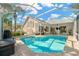 Inviting pool area with covered patio, seating, and a large screened enclosure at 4325 Swift Cir, Valrico, FL 33596