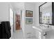 Stylish bathroom with pedestal sink and black and white tile floor at 4811 Culbreath Isles Rd, Tampa, FL 33629