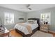 Comfortable bedroom with a dark gray upholstered bed and mirror at 4811 Culbreath Isles Rd, Tampa, FL 33629