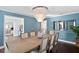 Formal dining room with a rustic wooden table and a stunning chandelier at 4811 Culbreath Isles Rd, Tampa, FL 33629