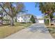 Two-story house with a large yard, driveway, and mature trees at 4811 Culbreath Isles Rd, Tampa, FL 33629