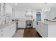 White kitchen with stainless steel appliances and marble countertops at 4811 Culbreath Isles Rd, Tampa, FL 33629