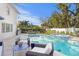 Relaxing pool area with patio furniture and lush landscaping at 4811 Culbreath Isles Rd, Tampa, FL 33629