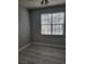 Bedroom with a fan, a window with blinds, gray walls, and stylish hardwood floors at 501 Knights Run Ave # 1113, Tampa, FL 33602