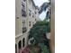 A lovely apartment exterior with black balcony railing overlooking a lush garden and a glimpse of covered parking at 501 Knights Run Ave # 1113, Tampa, FL 33602