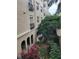 A lovely apartment exterior with black balcony railing overlooking a lush garden and a glimpse of covered parking at 501 Knights Run Ave # 1113, Tampa, FL 33602