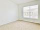 Well-lit bedroom with large window and carpet at 5010 Cactus Needle Ln, Wesley Chapel, FL 33544