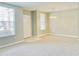 Bright living room with tile entrance, neutral carpet, and large window with white blinds at 5010 Cactus Needle Ln, Wesley Chapel, FL 33544