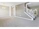 Large living room featuring stairs with white railings and open space at 5010 Cactus Needle Ln, Wesley Chapel, FL 33544