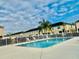 Community pool with lounge chairs at 5010 Cactus Needle Ln, Wesley Chapel, FL 33544