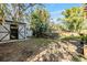 View of backyard with multiple sheds and green space at 5043 Mockingbird Dr, Dade City, FL 33523