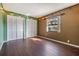 Bright bedroom with dark laminate wood flooring and built-in shelving at 5043 Mockingbird Dr, Dade City, FL 33523