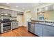 Modern kitchen with gray cabinets, stainless steel appliances, and granite countertops at 5043 Mockingbird Dr, Dade City, FL 33523