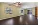 Large living room with dark laminate wood flooring and lots of natural light at 5043 Mockingbird Dr, Dade City, FL 33523