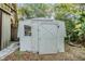 Small storage shed with single door and window at 5043 Mockingbird Dr, Dade City, FL 33523