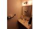 Updated bathroom with vanity, mirror, and wood-look flooring at 562 Andorra Ne Cir # 562, St Petersburg, FL 33703