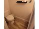 Clean bathroom with white toilet and wood-look flooring at 562 Andorra Ne Cir # 562, St Petersburg, FL 33703