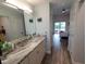 Bright bathroom with double vanity and view into bedroom at 562 Andorra Ne Cir # 562, St Petersburg, FL 33703