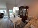 Dining area with white table, wooden hutch, and hardwood floors at 562 Andorra Ne Cir # 562, St Petersburg, FL 33703