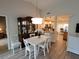 White dining set in bright dining room with view of kitchen at 562 Andorra Ne Cir # 562, St Petersburg, FL 33703