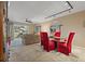 Bright dining area with red chairs and glass table, overlooking the patio at 6085 Bahia Del Mar Blvd # 105, St Petersburg, FL 33715