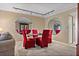 Dining area with red chairs and glass table, features two large circular mirrors at 6085 Bahia Del Mar Blvd # 105, St Petersburg, FL 33715