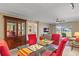 Dining area with red chairs and glass table, view into living room and patio at 6085 Bahia Del Mar Blvd # 105, St Petersburg, FL 33715