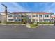 Exterior view of a two-story building with red tile roofs and palm trees at 6085 Bahia Del Mar Blvd # 105, St Petersburg, FL 33715