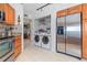 Laundry room with washer, dryer and additional storage at 6085 Bahia Del Mar Blvd # 105, St Petersburg, FL 33715