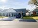 Front exterior view of a light blue house with a carport and landscaping at 6103 Elmhurst Dr, New Port Richey, FL 34653