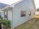 Exterior view of the house showcasing a light blue painted wall at 6103 Elmhurst Dr, New Port Richey, FL 34653