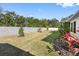 Landscaped backyard with a privacy wall at 6210 Nikki Ln, Odessa, FL 33556