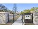 Community entrance with a black metal gate at 6210 Nikki Ln, Odessa, FL 33556