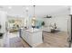 Kitchen island with granite countertops and stainless steel dishwasher overlooks living room at 6210 Nikki Ln, Odessa, FL 33556