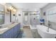 Elegant bathroom with double vanity, soaking tub, and walk-in shower at 6327 Emerson S Ave, St Petersburg, FL 33707